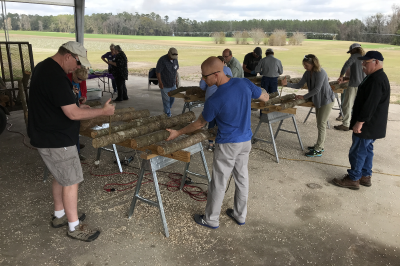 Students working on logs